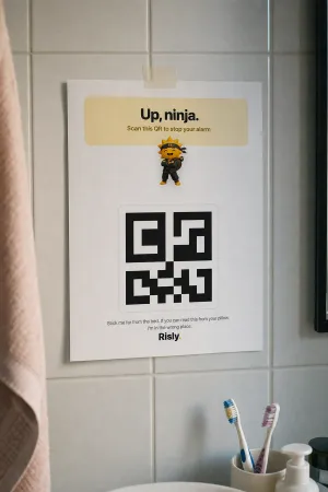 Risly's QR mission on iPhone: the camera aimed at a printed QR code across the room.