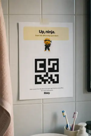 Risly's QR mission on iPhone: the camera aimed at a printed QR code across the room.